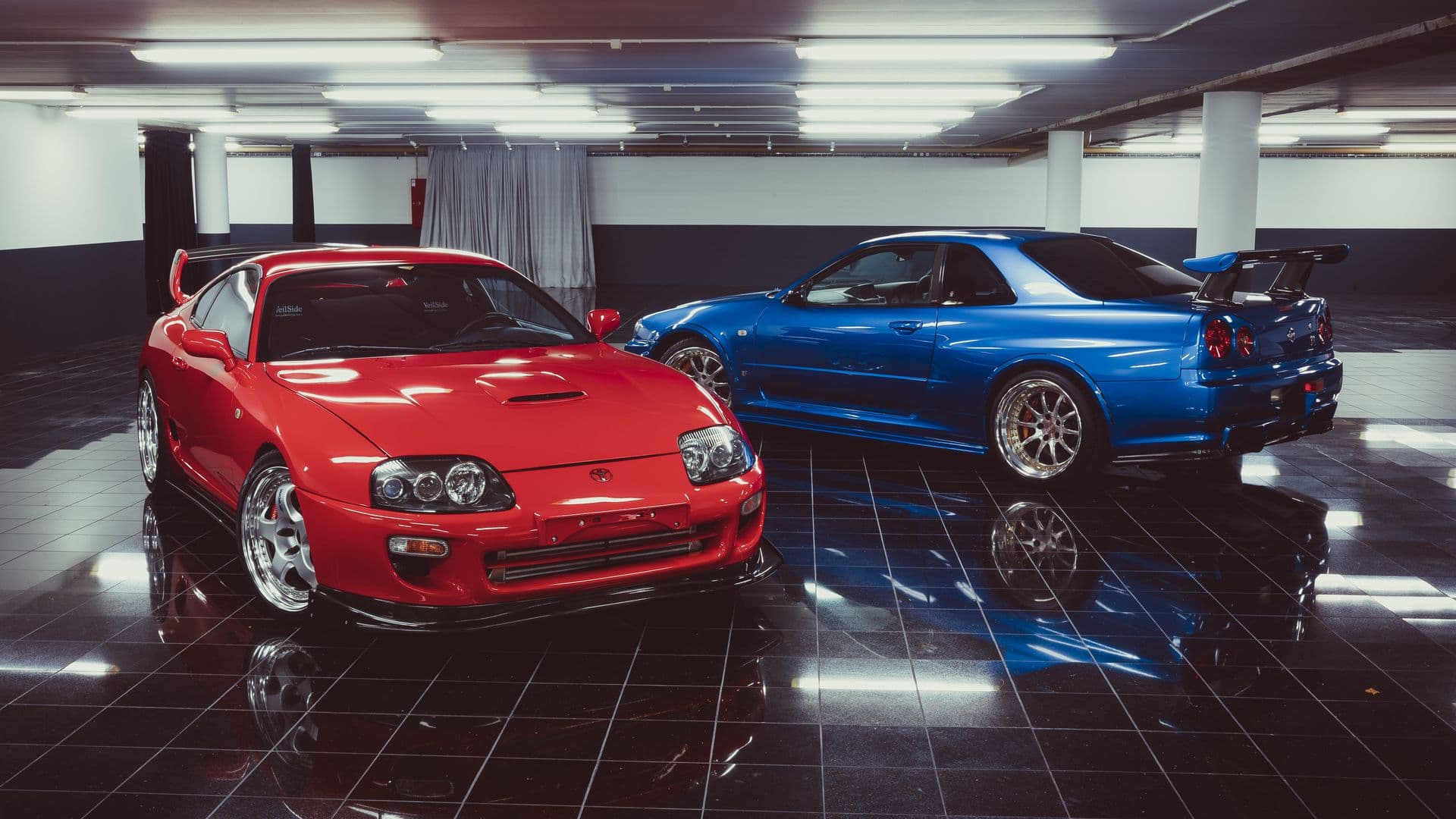 A Toyota Supra and Nissan Skyline GT-R in a private garage