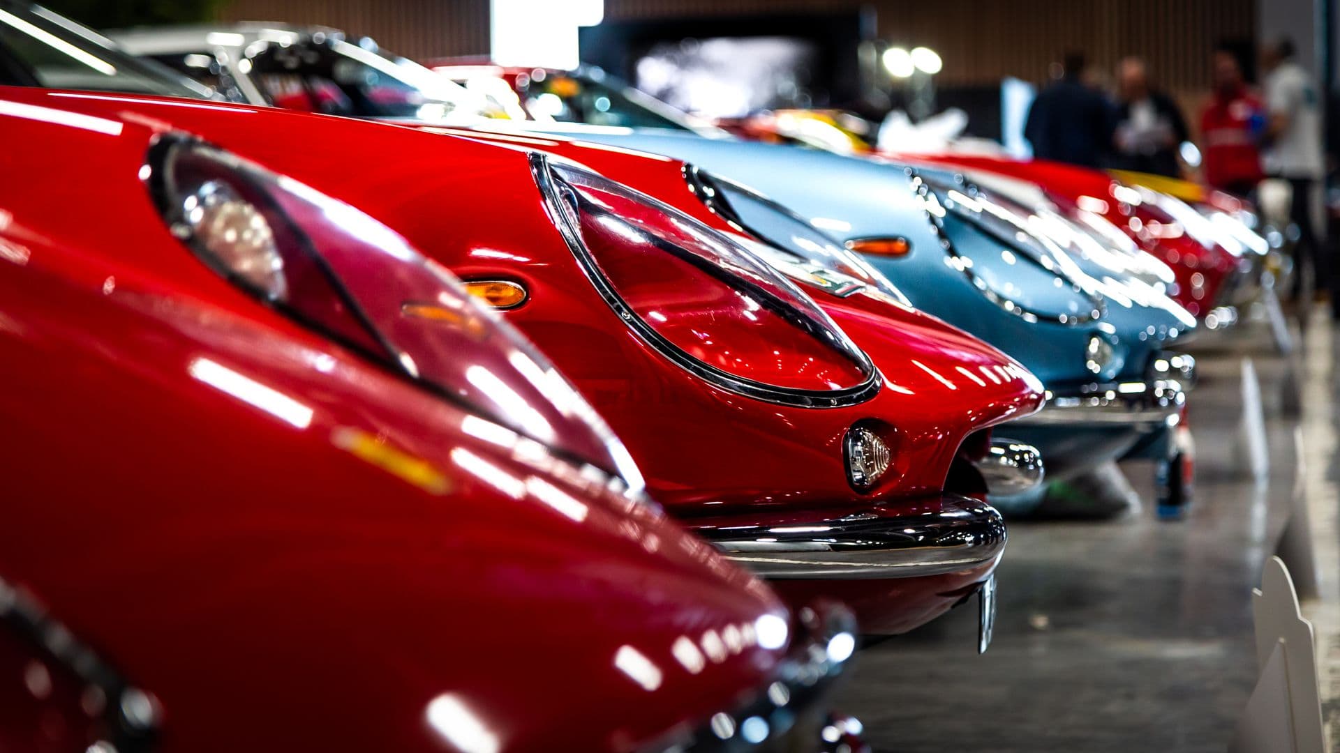 A lineup of vintage sports cars in a showroom